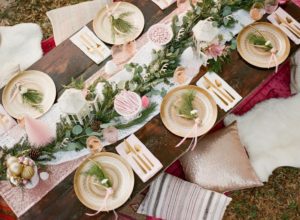pink and gold bohemian table for holiday party outside