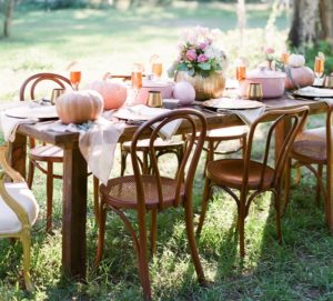 vintage bentwood chairs and farmtable with pink and gold table decor