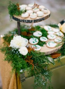 woodsy dessert station with hand-painted macarons and cookies