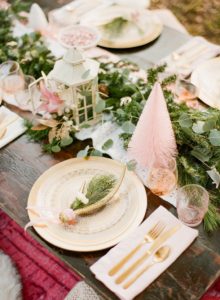 pink boho christmas tablescape with greenery garland