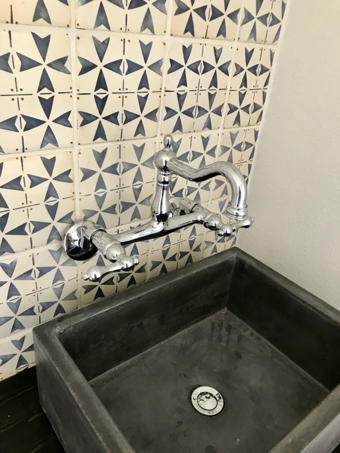 powder room tile wall and concrete sink