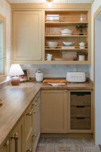 yellow farmhouse pantry with wood drawers